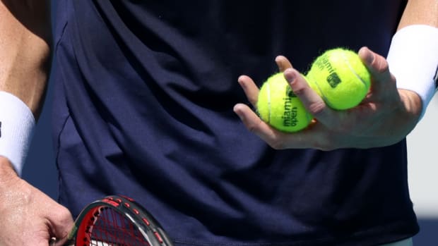 Mar 28, 2021; Miami, Florida, USA; John Isner of the United States holds four balls in his hand prior to serving against Felix Auger-Aliassime of Canada (not pictured) in the third round in the Miami Open at Hard Rock Stadium. Mandatory Credit: Geoff Burke-USA TODAY Sports