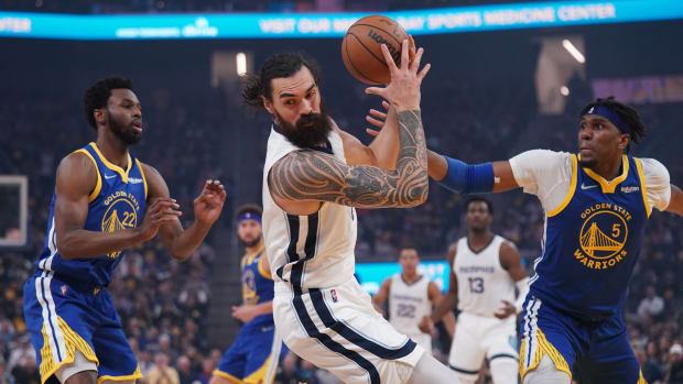 May 13, 2022; San Francisco, California, USA; Memphis Grizzlies center Steven Adams (4) holds onto a rebound next to Golden State Warriors forward Andrew Wiggins (22) and forward Kevon Looney (5) in the first quarter during game six of the second round for the 2022 NBA playoffs at Chase Center. Mandatory Credit: Cary Edmondson-USA TODAY Sports