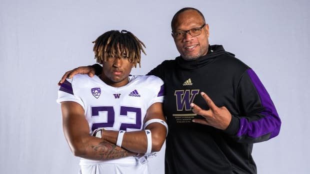 Jordan Whitney and UW co-defensive coordinator William Inge share a moment.