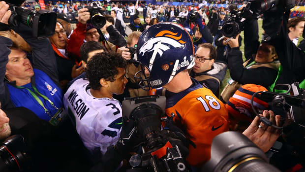 Peyton Manning and Russell Wilson embrace after the Super Bowl.