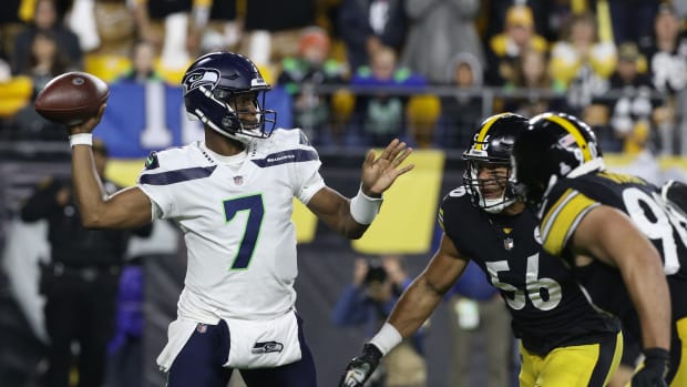 Seattle Seahawks quarterback Geno Smith (7) passes against pressure from Pittsburgh Steelers outside linebacker Alex Highsmith (56) and outside linebacker T.J. Watt (90) during the first quarter at Heinz Field.