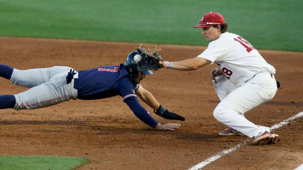 Alabama first baseman Drew Williamson (18) takes a pick off throw at first but can't tag out Auburn base runner Cole Foster in Sewell-Thomas Stadium Thursday, April 15, 2021