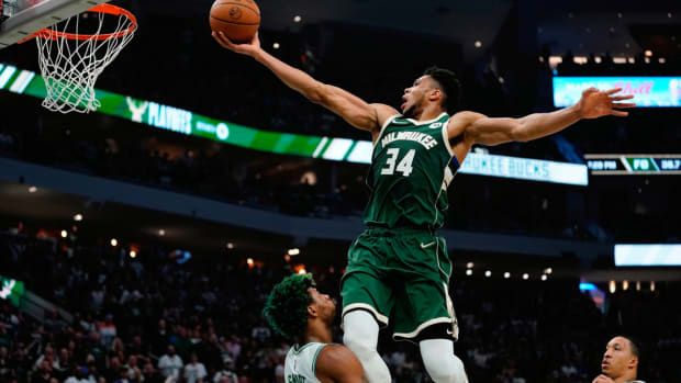 Milwaukee Bucks’ Giannis Antetokounmpo shoots over Boston Celtics’ Marcus Smart during the first half of Game 6 of an NBA basketball Eastern Conference semifinals playoff series Friday, May 13, 2022, in Milwaukee . (AP Photo/Morry Gash)