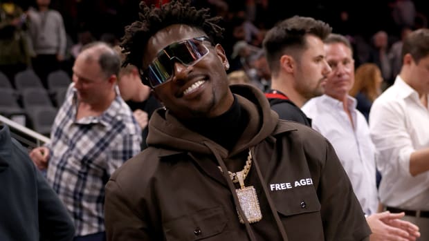 Former Buccaneers wide receiver Antonio Brown poses for photographers after the game between the Hawks and the Clippers at State Farm Arena.