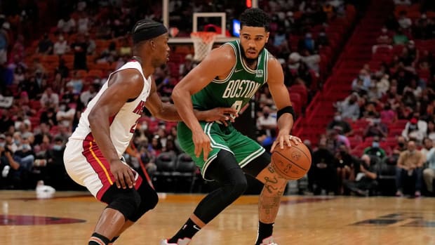 Oct 15, 2021; Miami, Florida, USA; Boston Celtics forward Jayson Tatum (0) dribbles the ball around Miami Heat forward Jimmy Butler (22) during the second half at FTX Arena.