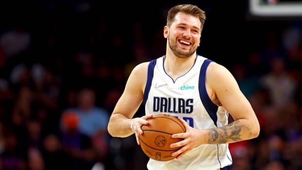 Luka Doncic smiles on the court