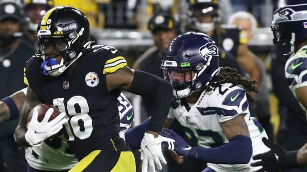 Pittsburgh Steelers wide receiver Diontae Johnson (18) runs after a catch as Seattle Seahawks cornerback Sidney Jones (23) and middle linebacker Bobby Wagner (54) chase during the second quarter at Heinz Field.