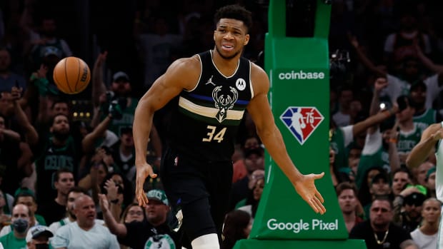 Milwaukee Bucks forward Giannis Antetokounmpo (34) gestures at Boston Celtics forward Grant Williams (12) who fell to the ground as Antetokounmpo made a basket during the first quarter of game seven of the second round of the 2022 NBA playoffs.