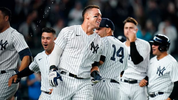 New York Yankees’ Aaron Judge celebrates with teammates after hitting a walk-off three-run home run during the ninth inning of a baseball game against the Toronto Blue Jays Tuesday, May 10, 2022, in New York. The Yankees won 6-5.