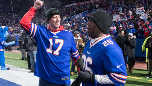 Jan 15, 2022; Orchard Park, New York, USA; NFL Hall of Fame members and former Buffalo Bills players Jim Kelly (left) and Thurman Thomas prepare to get the crowd fired up before an AFC Wild Card playoff football game against the New England Patriots at Highmark Stadium. Mandatory Credit: Mark Konezny-USA TODAY Sports
