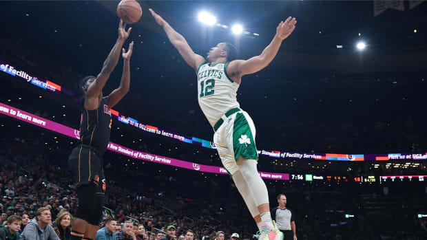 Mar 30, 2022; Boston, Massachusetts, USA; Miami Heat forward Jimmy Butler (22) shoots the ball past Boston Celtics forward Grant Williams (12) during the first half at TD Garden.