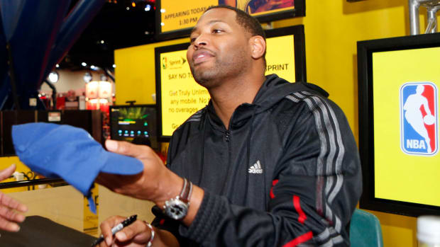 Feb 16, 2013; Houston, TX, USA; NBA former player Robert Horry (right) signs autographs for fans at the 2013 NBA jam session at the George R. Brown Convention Center.
