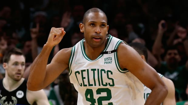Boston Celtics center Al Horford (42) pumps his fist as he heads back up court after hitting a basket against the Milwaukee Bucks during the second half of game seven of the second round of the 2022 NBA playoffs.