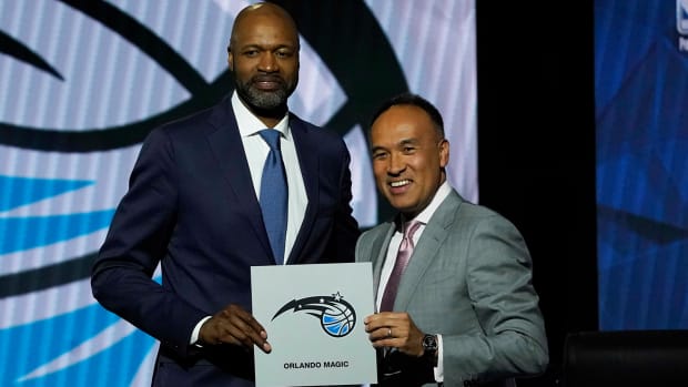 Orlando Magic head coach Jamahl Mosley and NBA deputy commissioner Mark Tatum pose after Orlando Magic won the first pick during the 2022 NBA Draft Lottery.