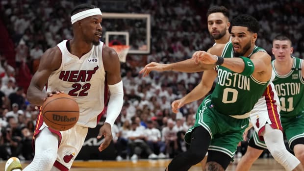 Miami Heat forward Jimmy Butler (22) moves the ball up court against Boston Celtics forward Jayson Tatum.
