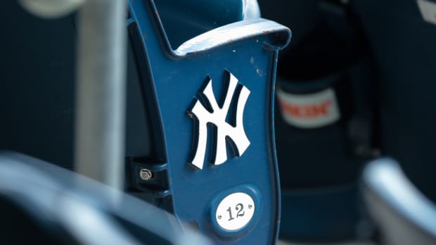 A view of the New York Yankees logo and seat number of an empty seat.