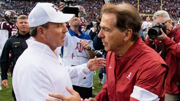 Texas A&M head coach Jimbo Fisher, left, and Alabama head coach Nick Saban meet at midfield after their game in College Station, Texas, in 2019.