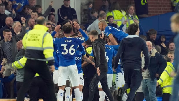 Everton players and fans celebrate the goal which saw them avoid relegation from the Premier League in May 2022