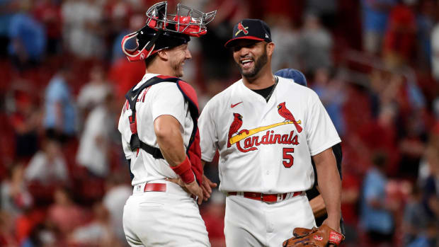 St. Louis Cardinals catcher Andrew Knizner (7) and teammate Albert Pujols celebrate their team’s 15-6 victory over the San Francisco Giants after a baseball game on Sunday, May 15, 2022, in St. Louis.