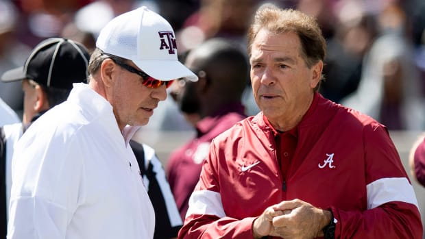 Jimbo Fisher and  Nick Saban chat at midfield before their game at Kyle Field in College Station, Texas.