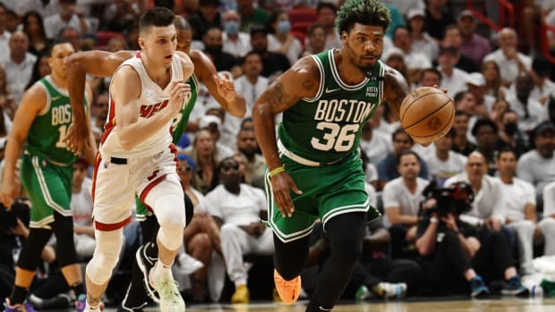 May 19, 2022; Miami, Florida, USA; Boston Celtics guard Marcus Smart (36) brings the ball up court as Miami Heat guard Tyler Herro (14) defends during the first half of game two of the 2022 eastern conference finals at FTX Arena. Mandatory Credit: Jim Rassol-USA TODAY Sports