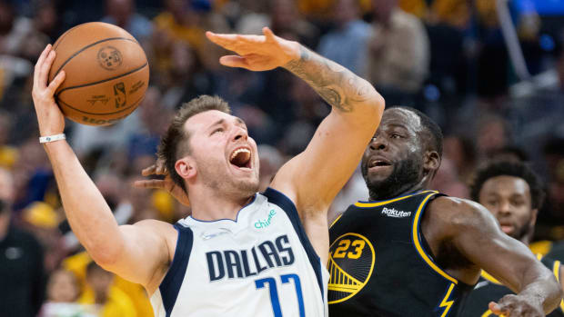 Dallas Mavericks guard Luka Doncic (77) shoots the basketball against Golden State Warriors forward Draymond Green (23) during the second quarter in game one of the 2022 western conference finals.