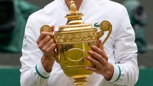 Novak Djokovic (SRB) holds the Wimbledon trophy in 2021.