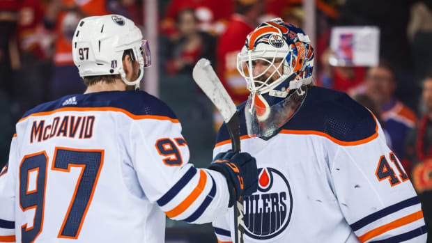 May 20, 2022; Calgary, Alberta, CAN; Edmonton Oilers goaltender Mike Smith (41) celebrate win with center Connor McDavid (97) against the Calgary Flames in game two of the second round of the 2022 Stanley Cup Playoffs at Scotiabank Saddledome. Mandatory Credit: Sergei Belski-USA TODAY Sports