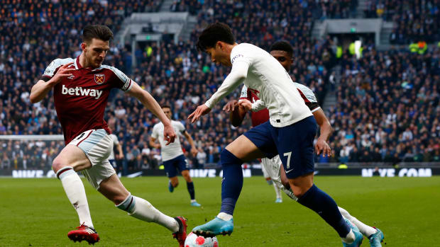 Tottenham's Son Heung-min (right) pictured running at West Ham's Declan Rice during a Premier League game in March 2022