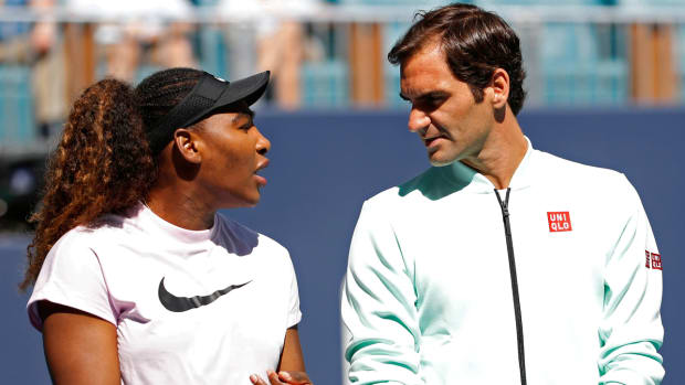 Serena Williams of the United States (L) speaks with Roger Federer of Switzerland (R) during a ribbon cutting ceremony.