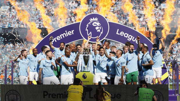 Manchester City's players pictured celebrating with the Premier League trophy at the end of the 2017/18 season - when they won a record-breaking 100 points