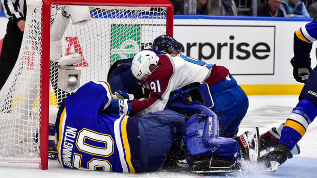 May 21, 2022; St. Louis, Missouri, USA; Colorado Avalanche center Nazem Kadri (91) collides with St. Louis Blues goaltender Jordan Binnington (50) during the first period in game three of the second round of the 2022 Stanley Cup Playoffs at Enterprise Center. Mandatory Credit: Jeff Curry-USA TODAY Sports