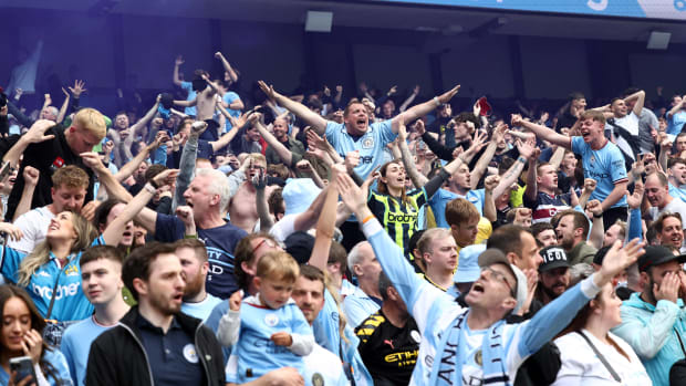 Manchester City fans pictured celebrating during their side's 3-2 win over Aston Villa in May 2022 which sealed the Premier League title on the final day of the season