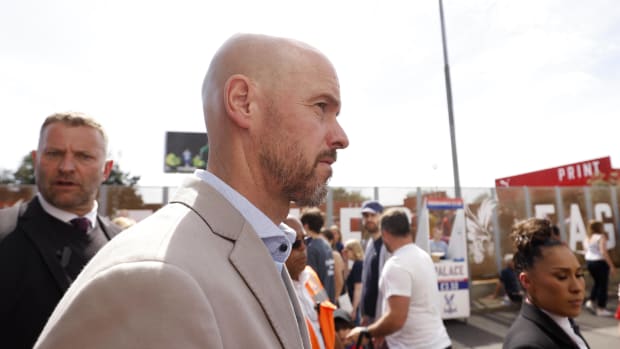 Erik ten Hag pictured outside Selhurst Park before Manchester United's game with Crystal Palace in May 2022 as his bodyguard (left) looks towards the camera