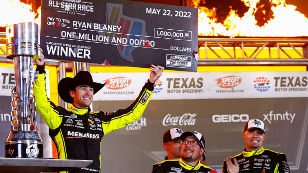 Ryan Blaney celebrates with the million dollar check in victory lane after winning Sunday night's NASCAR Cup All-Star Race at Texas Motor Speedway. (Photo by Jared C. Tilton/Getty Images)