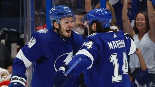 Tampa Bay Lightning left wing Pat Maroon (14) is congratulated by defenseman Mikhail Sergachev (98) as he scores a goal against the Florida Panthers during the third period at Amalie Arena.
