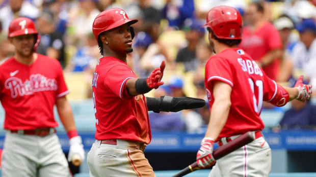 May 15, 2022; Los Angeles, California, USA; Philadelphia Phillies second baseman Jean Segura (2) is greeted by catcher Garrett Stubbs (21) after scoring a run against the Los Angeles Dodgers during the second inning at Dodger Stadium. Mandatory Credit: Gary A. Vasquez-USA TODAY Sports