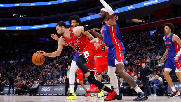 Bulls guard Zach LaVine (8) dribbles while being defended by Pistons forward Marvin Bagley III (35) and forward Jerami Grant (9).