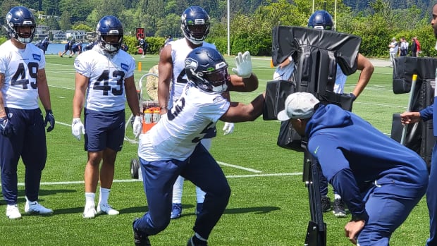Seahawks linebacker Boye Mafe works his hand technique against a blocking sled during organized team activities.