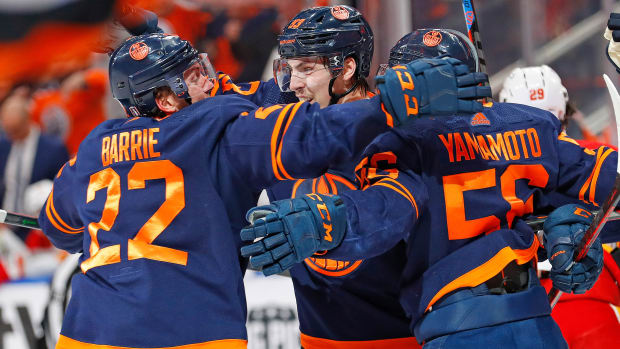 Oilers players celebrate a game winning goal by forward Ryan Nugent-Hopkins (93) against the Flames during the third period.