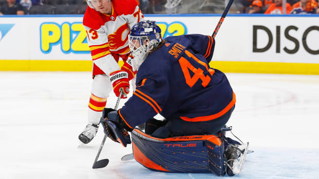 Oilers goaltender Mike Smith (41) makes a save on a shot by Flames forward Tyler Toffoli (73) during the second period in Game 4.