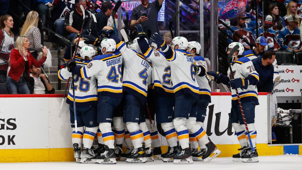 St. Louis Blues players celebrate after a game winning overtime goal from center Tyler Bozak (21) against the Colorado Avalanche in game five of the second round of the 2022 Stanley Cup Playoffs at Ball Arena.