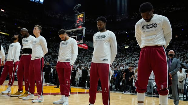 Miami Heat players pause for a moment of silence for those killed at the Robb Elementary School massacre in Uvalde, TX, before the start of Game 5 of the NBA basketball Eastern Conference finals playoff series against the Boston Celtics.
