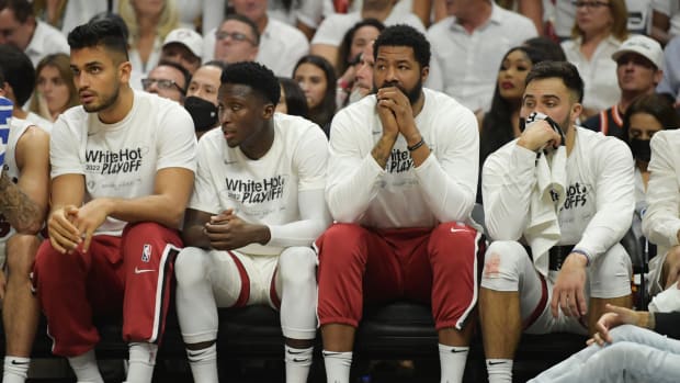 Despondent Heat players on the bench during their loss to the Celtics