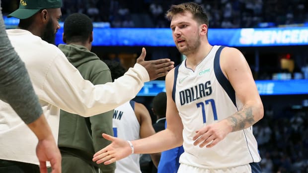 Dallas Mavericks guard Luka Doncic (77) is congratulated after a play against the Golden State Warriors during a time out during the third quarter in game four of the 2022 Western Conference finals.