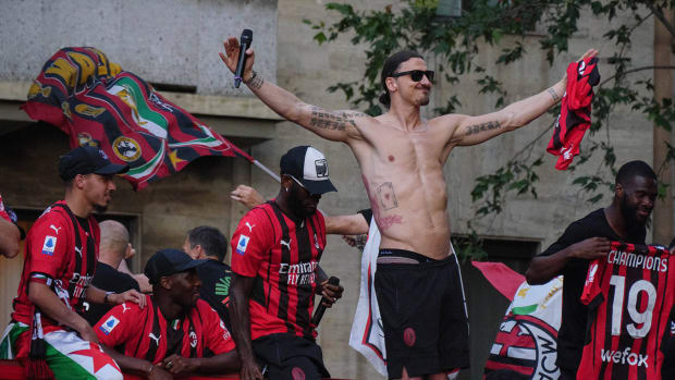 Franck Kessie, Zlatan Ibrahimovic of AC Milan celebrate during the Serie A Victory Parade on May 23, 2022 in Milan, Italy.