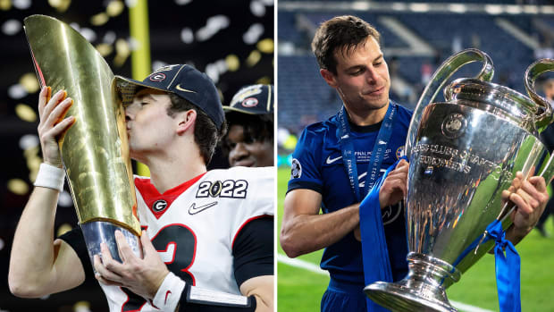 Georgia’s Stetson Bennett kisses the CFP trophy; Cesar Azpilicueta of Chelsea holds the Champions League trophy