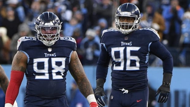 Tennessee Titans defensive end Jeffery Simmons (98) reacts after a play with defensive end Denico Autry (96) during the second half of an AFC Divisional playoff football game against the Cincinnati Bengals at Nissan Stadium.