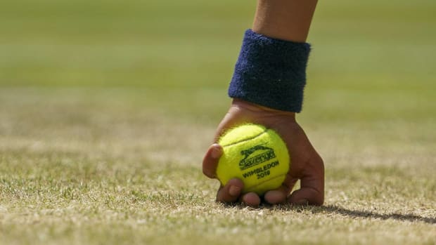 A ball boy holds a tennis ball at Wimbledon.