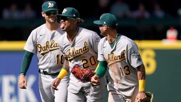 Oakland Athletics outfielders Chad Pinder (10), Cristian Pache (20) and Luis Barrera (13) head off the field after the Athletics defeated the Seattle Mariners 4-2 in a baseball game Wednesday, May 25, 2022, in Seattle.